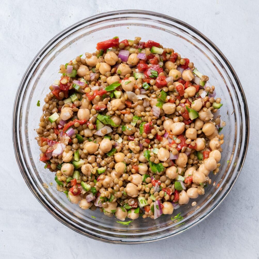 Final tossed salad in large bowl with spoon for scooping.
