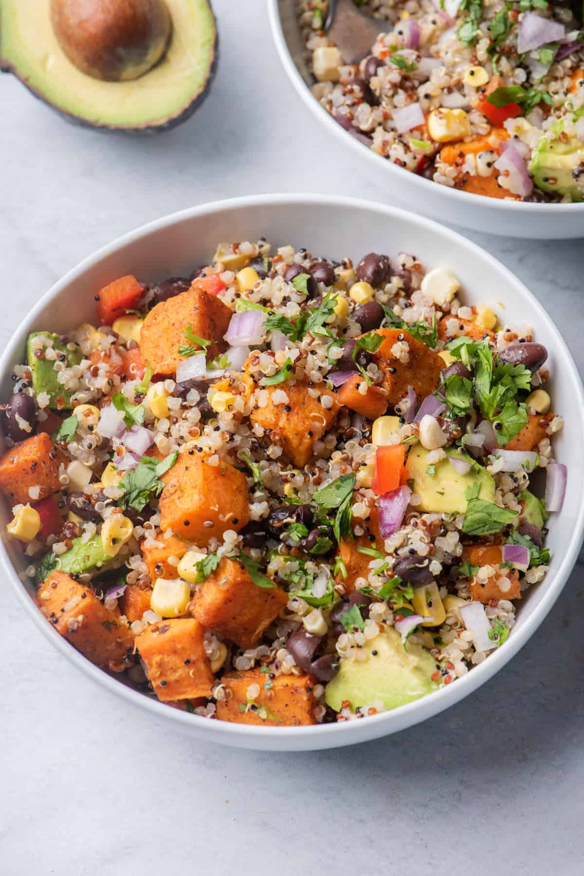 Close up shot of Southwest quinoa salad with avocado next to it