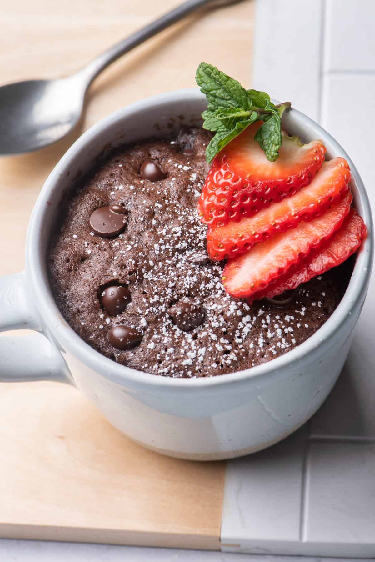 Vegan chocolate mug cake topped with strawberries