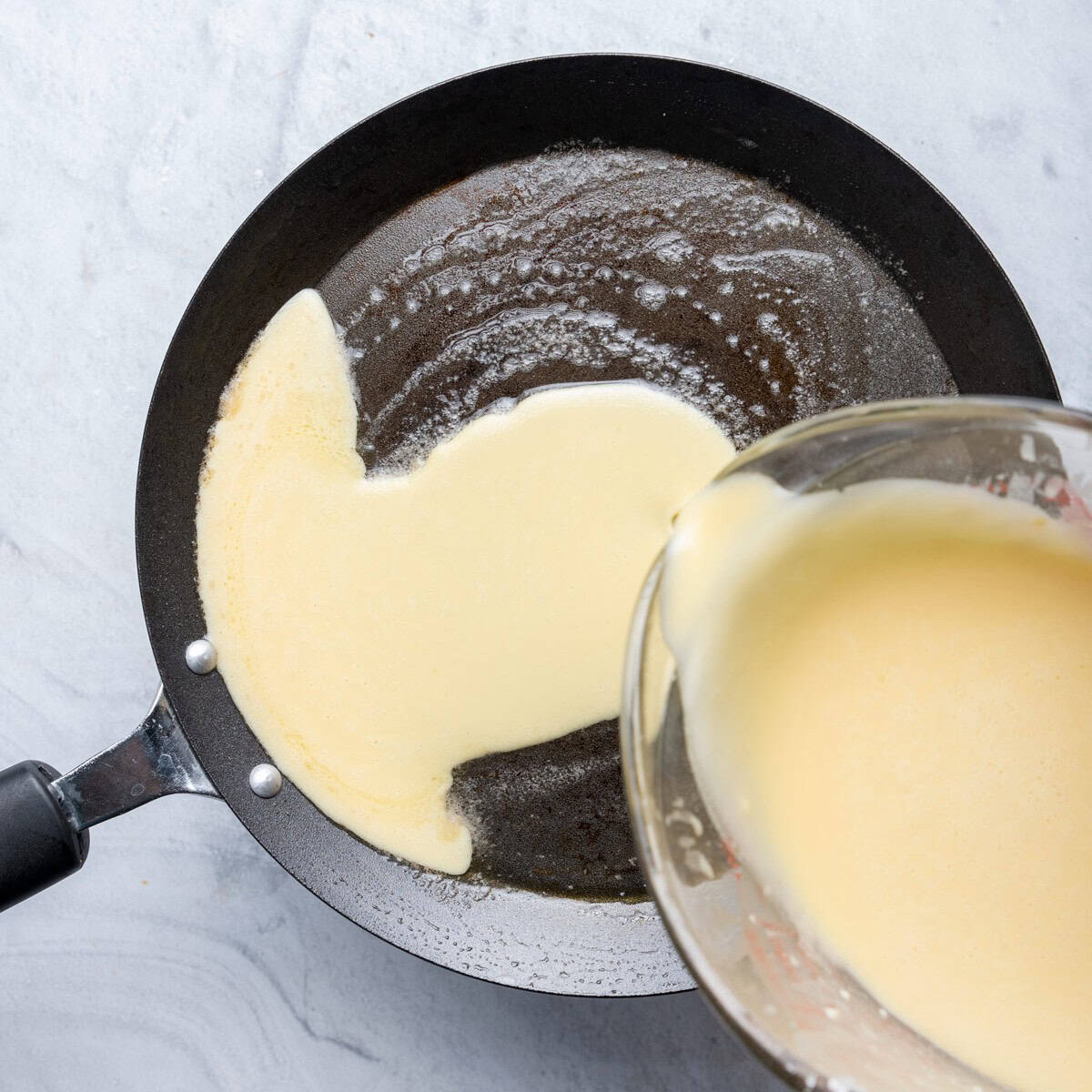 Pouring batter into the pan.