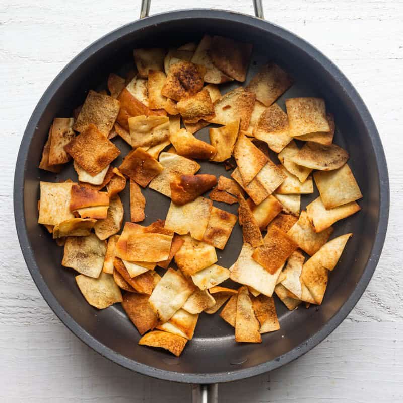 Pita bread in a pan after toasted on the stove.