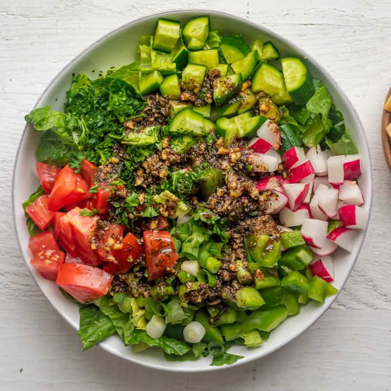 Dressing added on top of the mixed salad.