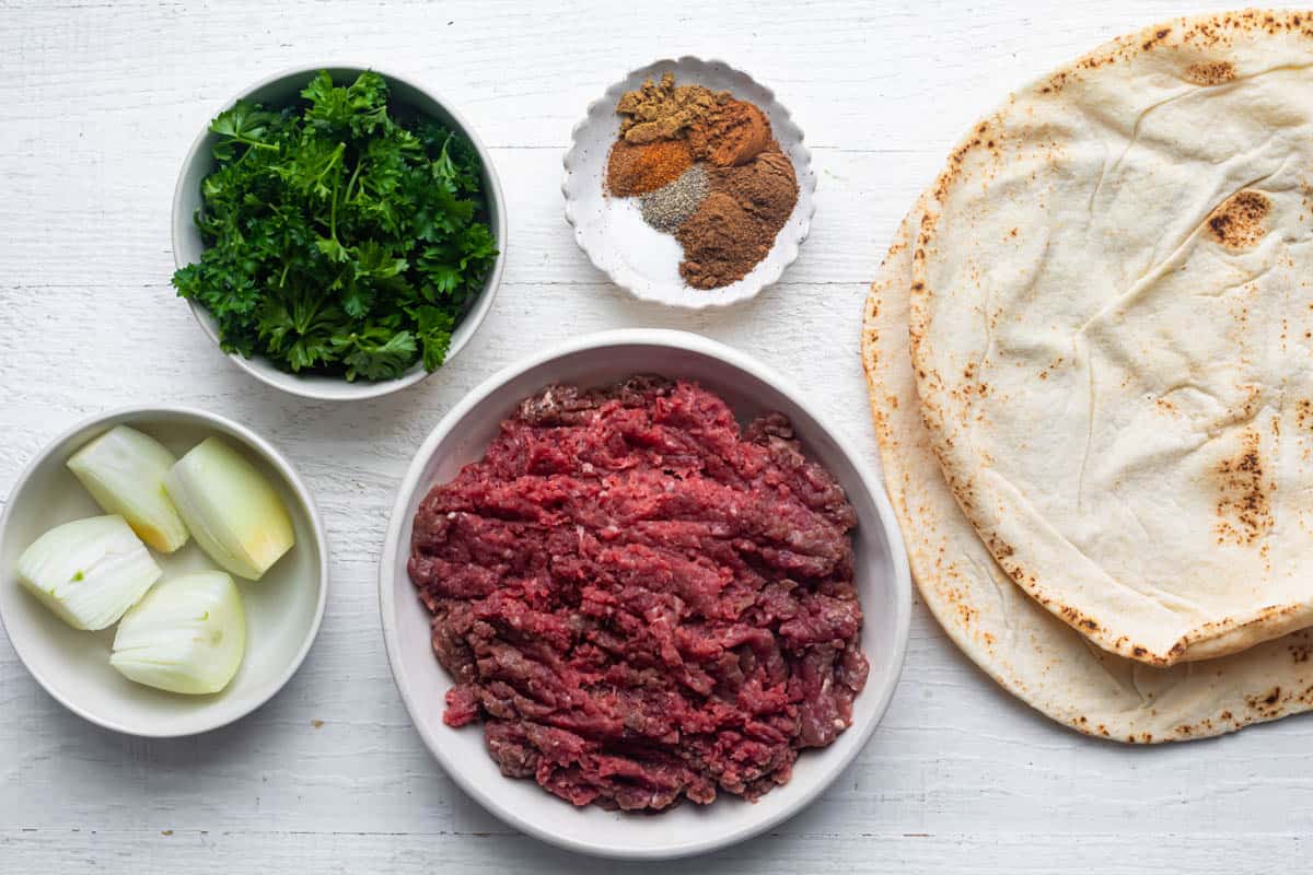 Ingredients to make the recipe: ground beef, onions, parsley, spices and pita