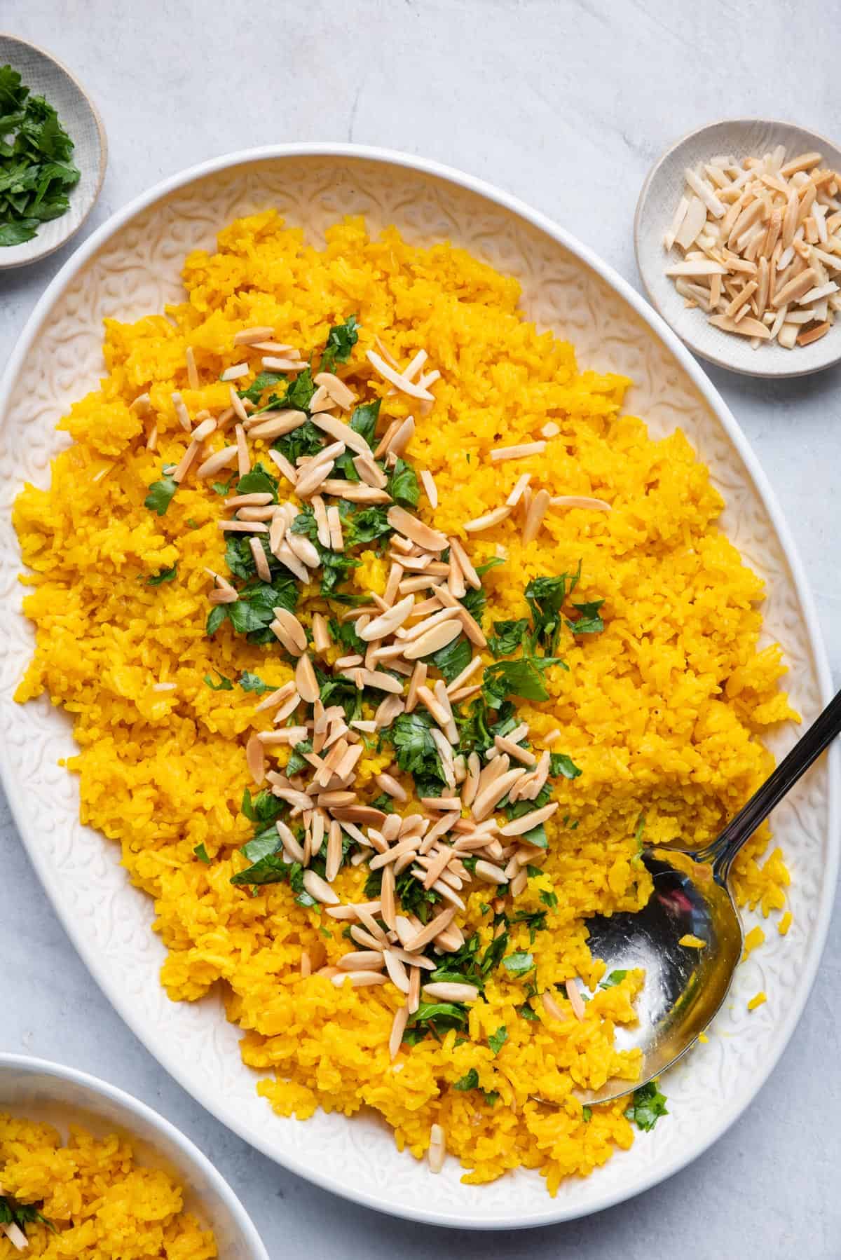 Turmeric rice with spoon inside for serving