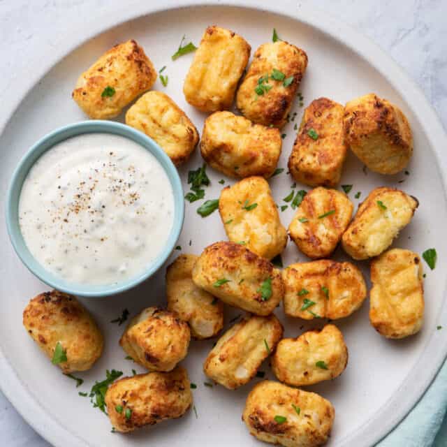 Cauliflower tater tots made in air fryer and served with a ranch dip