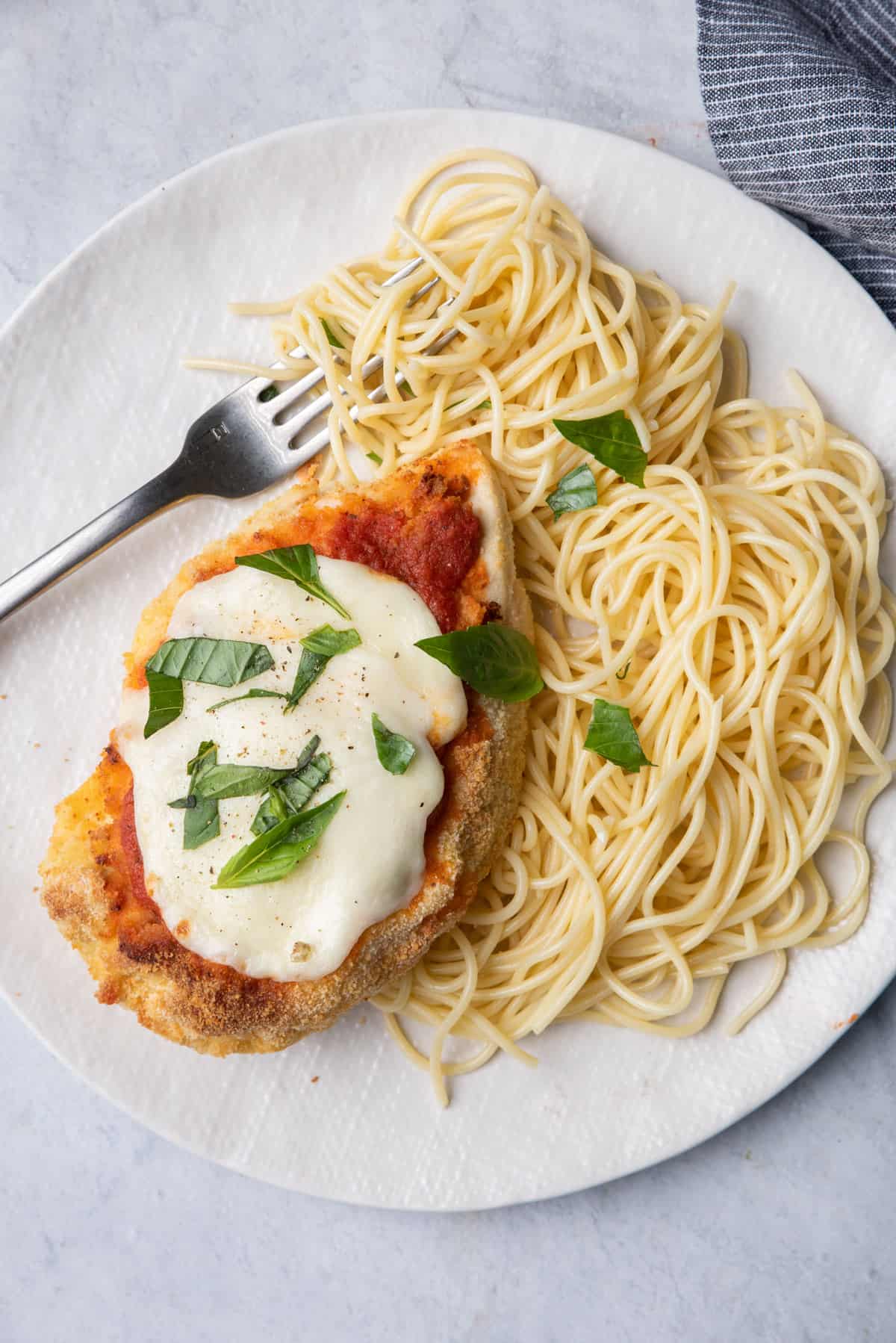 Chicken parmesan made in air fryer served with spaghetti on the side