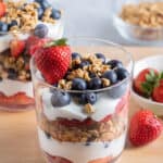 Fruit and yogurt parfait with red, white and blue fruits layered