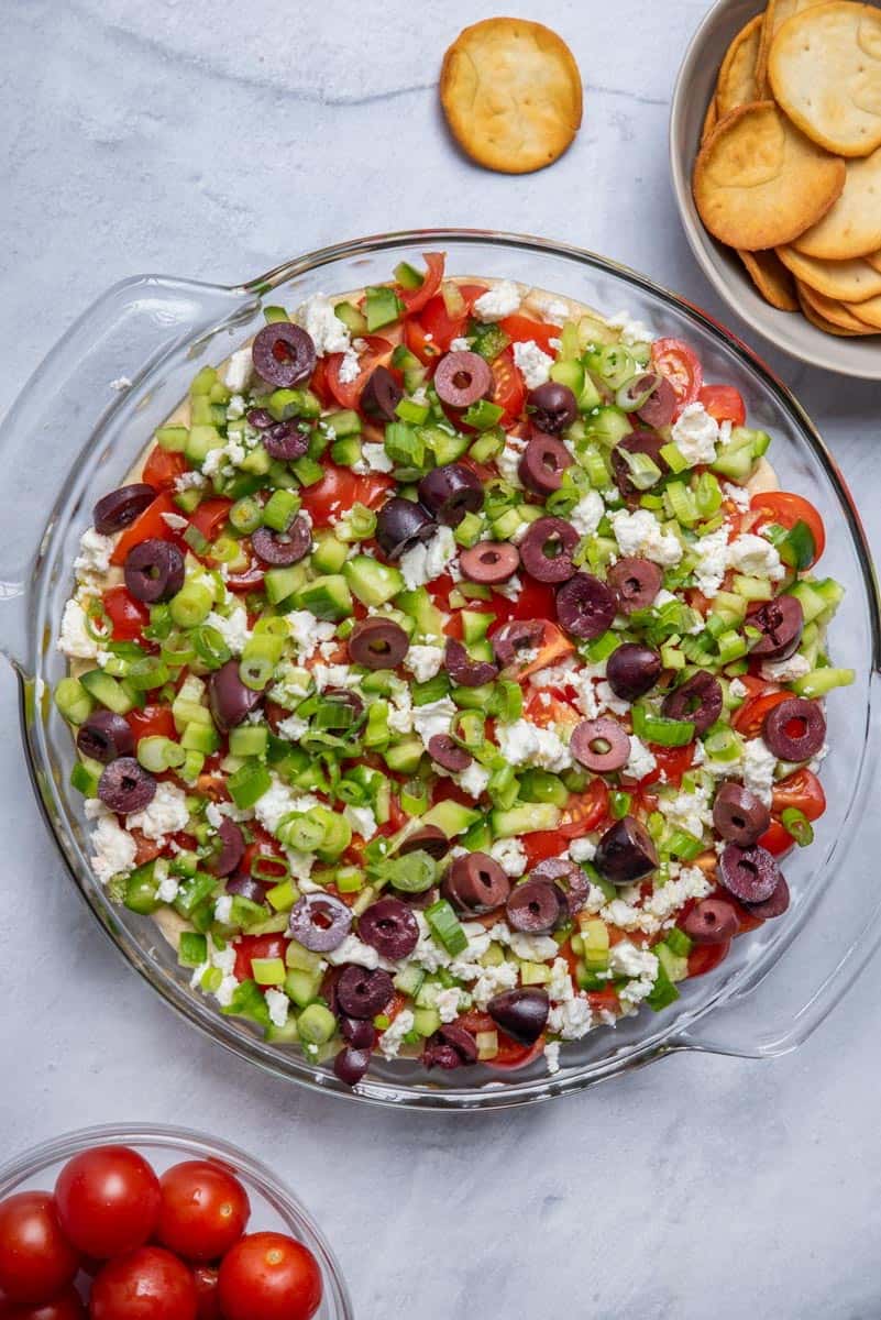 7 layer mediterranean dip with pita chips served on the side