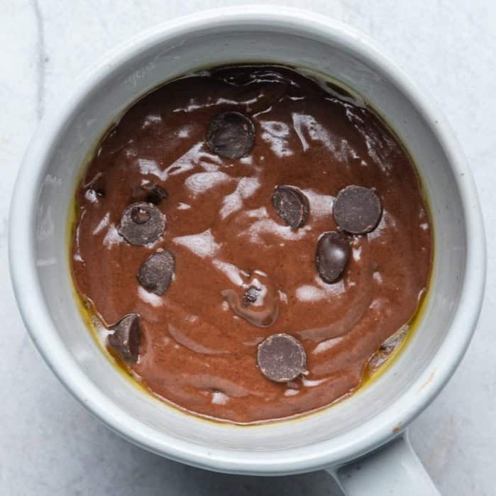 Chocolate chips added to the batter and transferred to a mug.