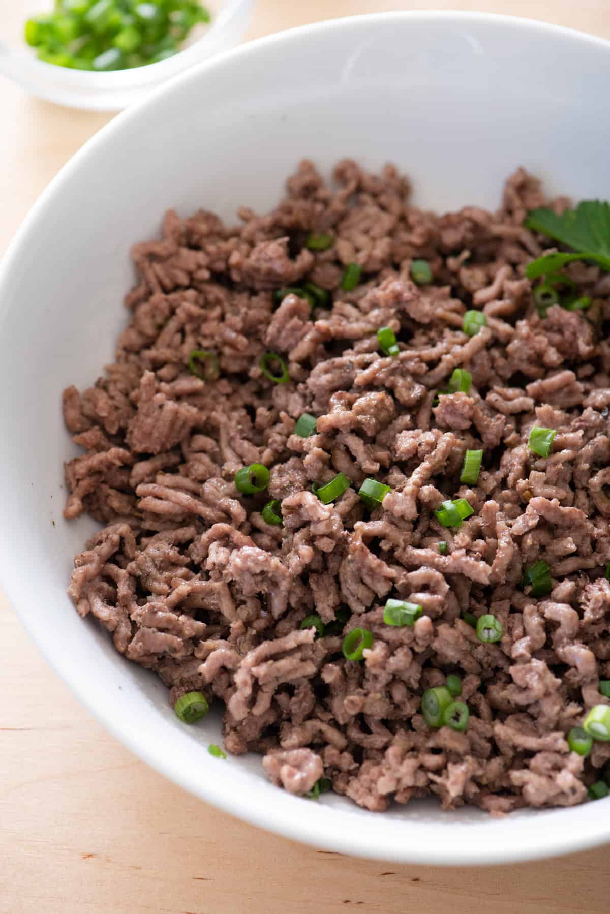 Instant pot ground beef served in large white bowl