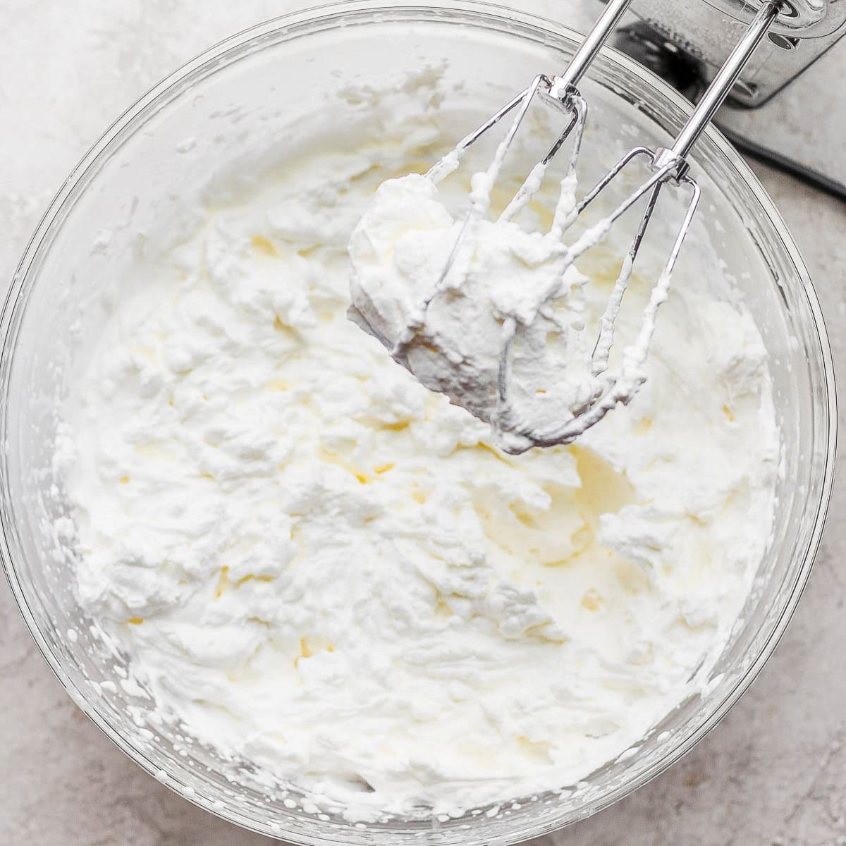 Mixer over the whipped cream bowl.