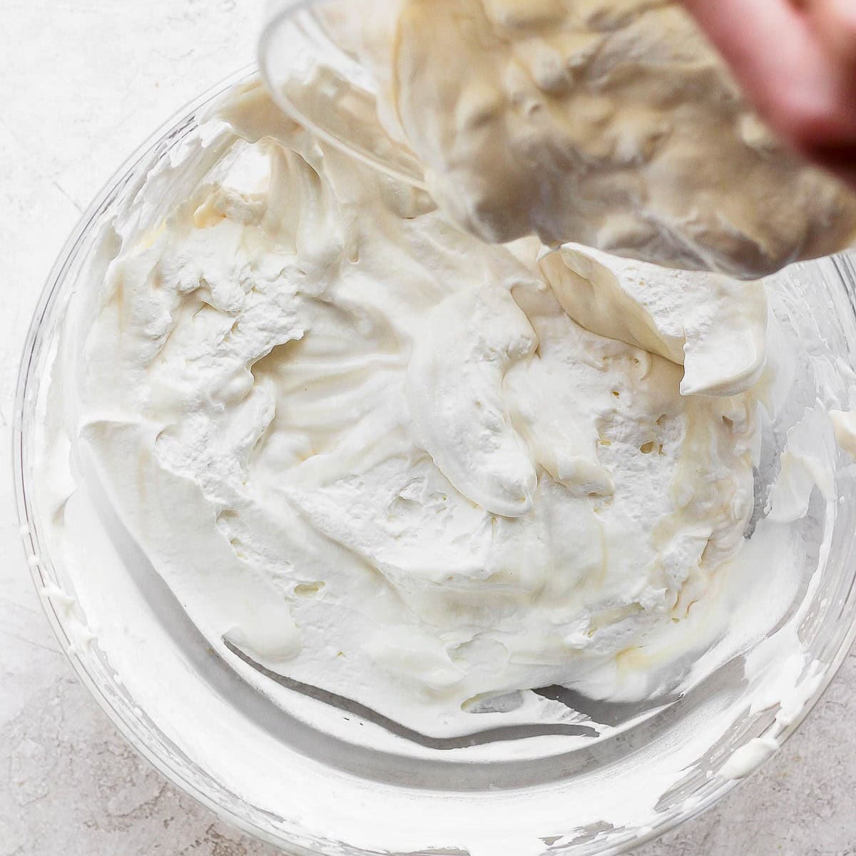 Pouring lightened mixture into remaining whipped cream.