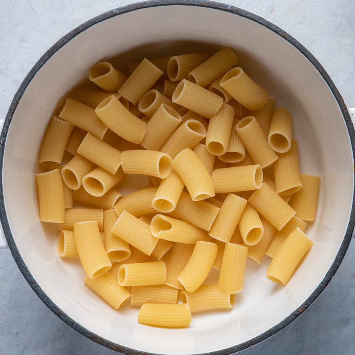 Uncooked pasta in empty pot.