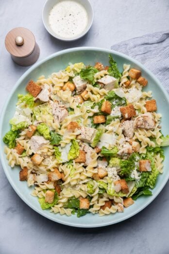 Chicken Caesar pasta salad in a large bowl with homemade croutons