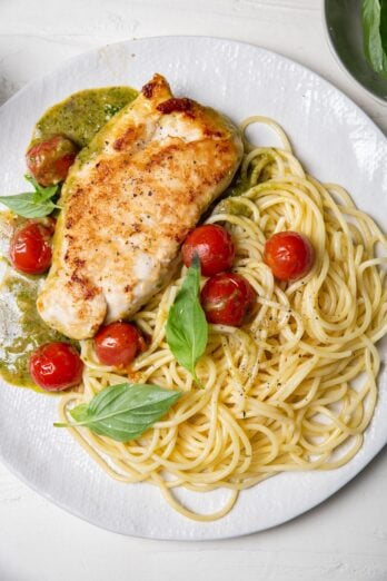 Creamy pesto chicken served with spaghetti and cherry tomatoes