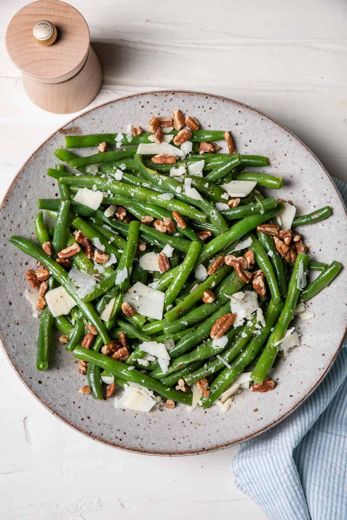 Bowl of green bean salad with honey dijon dressing and parmesan cheese