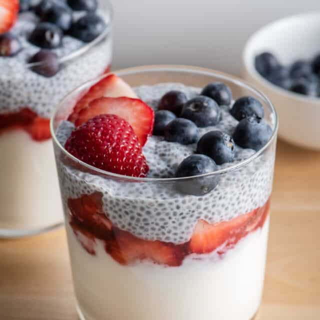 2 cups of yogurt chia parfait topped with blueberries and strawberries