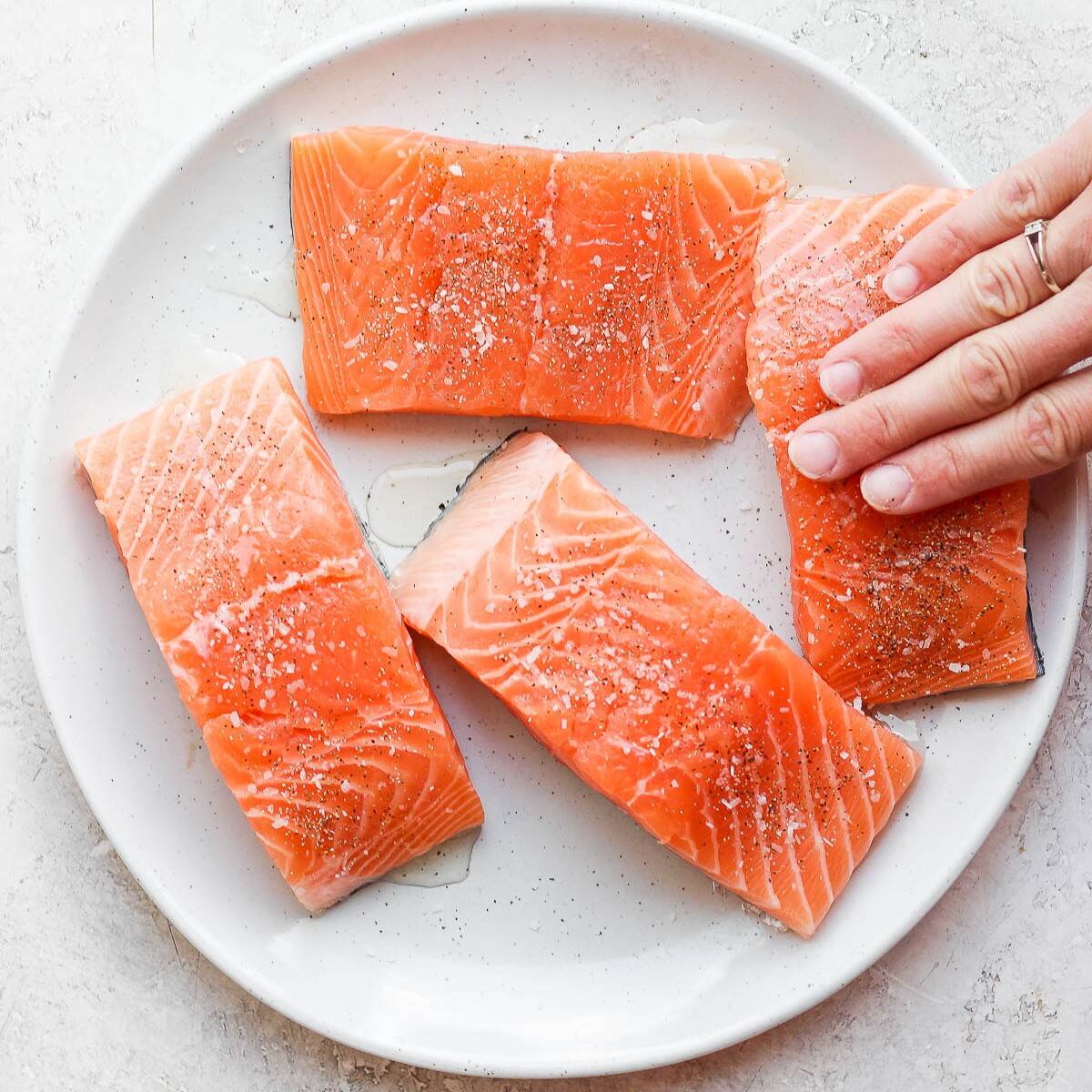 Rub oil on salmon.