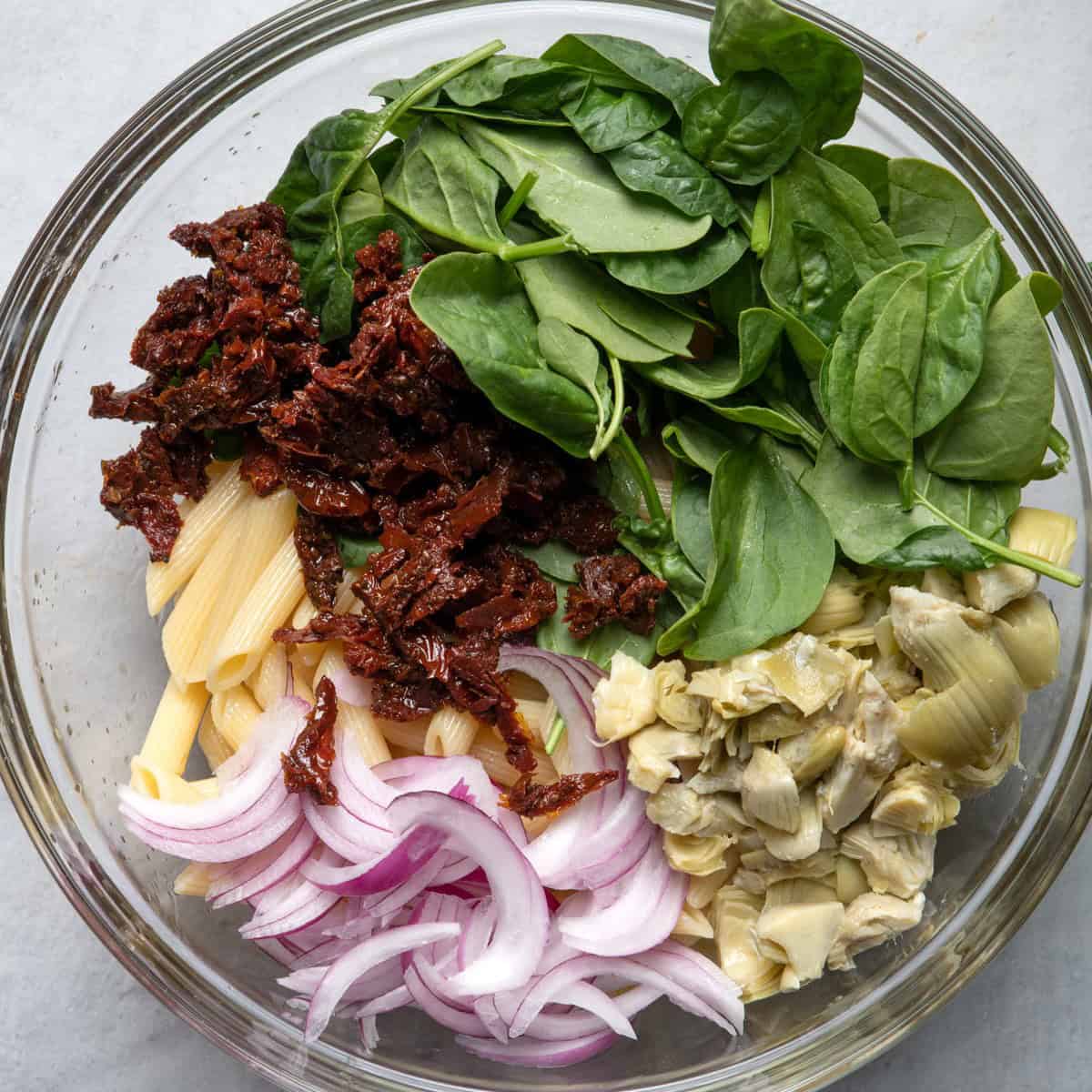 Other ingredients on top of the pasta in sections.