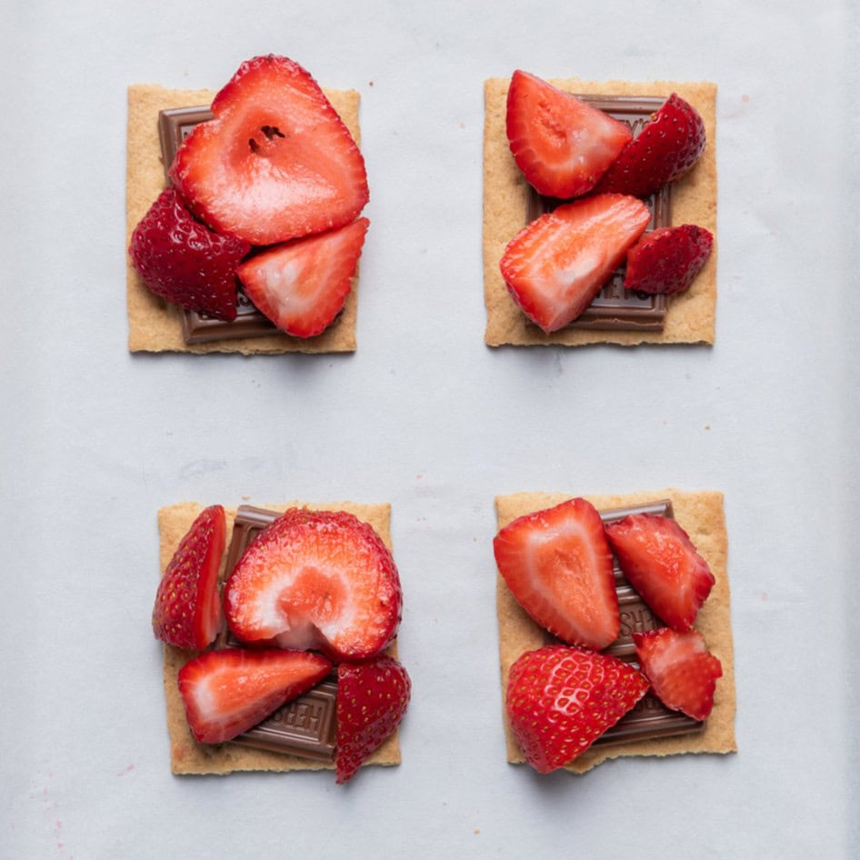 Graham crackers with chocolate, then strawberries on top.