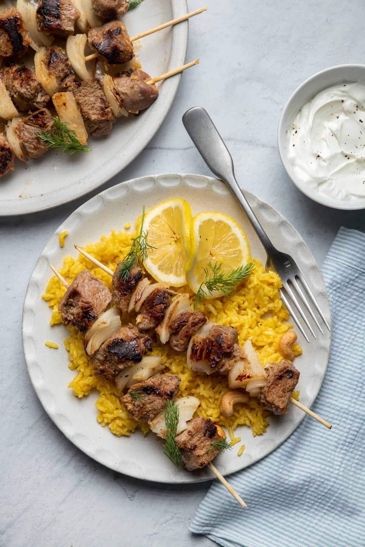 Plate of grilled lamb kabobs served over rice