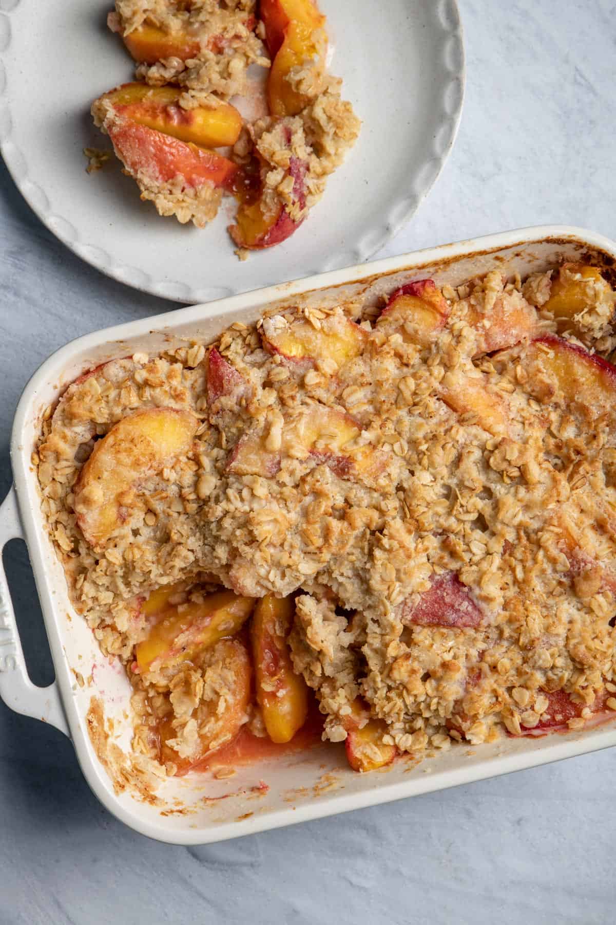 Large baking dish of the peach crisp and some served on the side