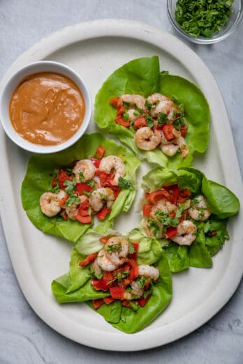 Shrimp lettuce wraps on platter served with peanut sauce