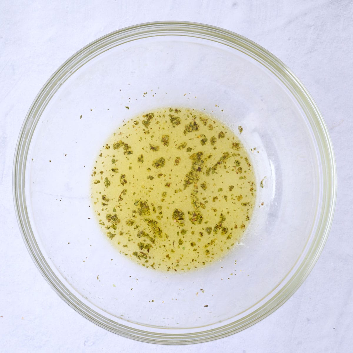 Lemon juice, oil, garlic, oregano, and salt in a large bowl after combining together.