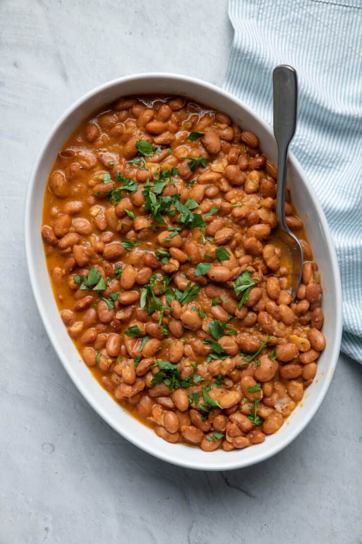 Large dish of instant pot baked beans garnished with parsley