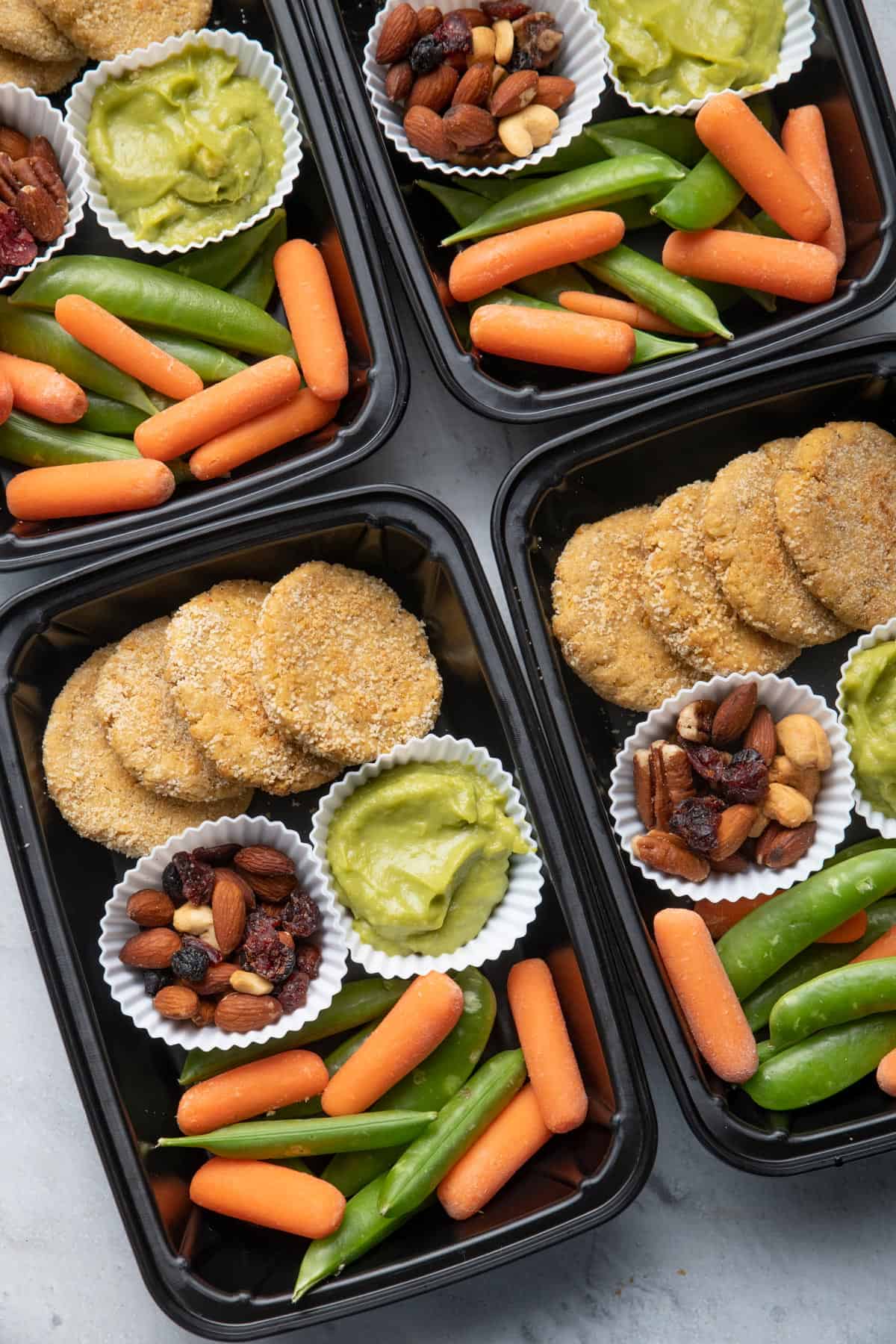 Meal prep containers with chickpea bites and avocado