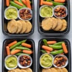 4 meal prep containers with the chickpea bites and avocado dip along with veggies and trail mix