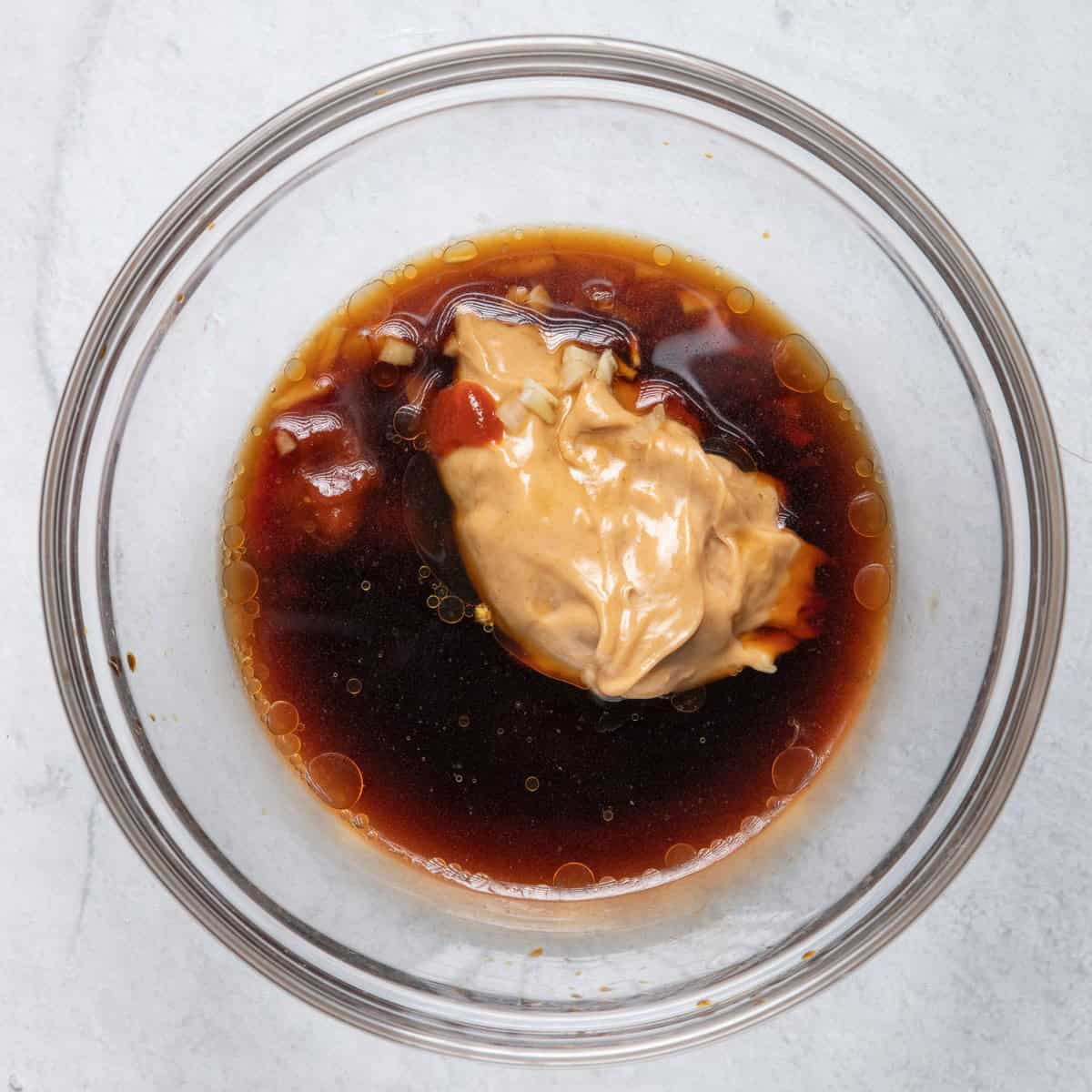 Ingredients for peanut sauce in small bowl.