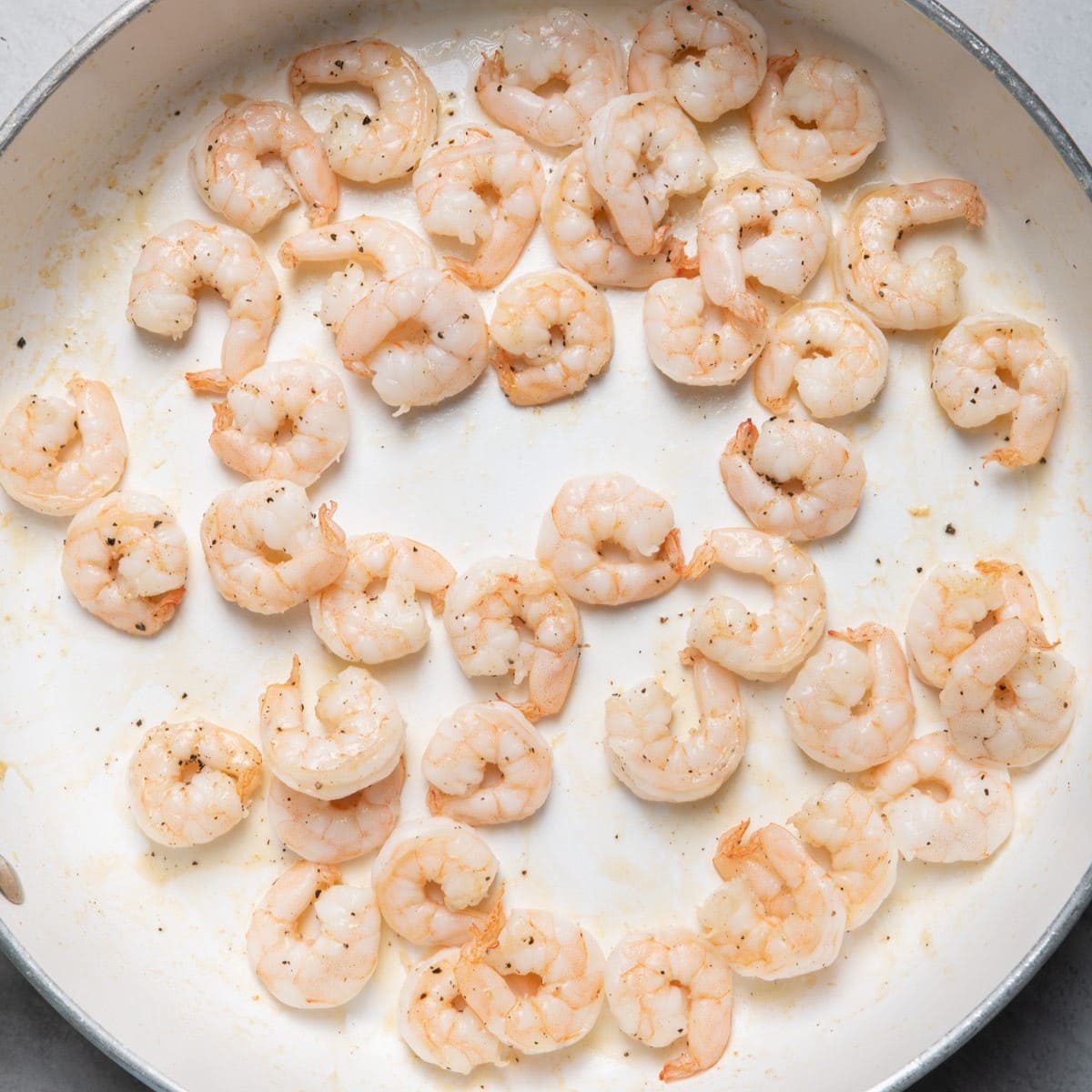 Cooked shrimp in skillet.