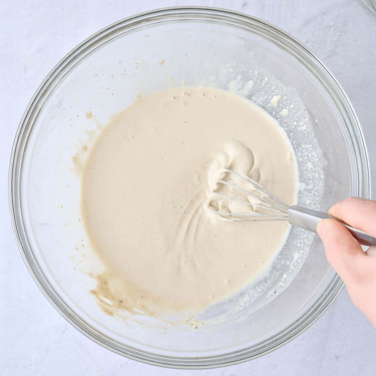 Tahini, lemon juice, garlic, cumin, salt and pepper in a large bowl after combining.
