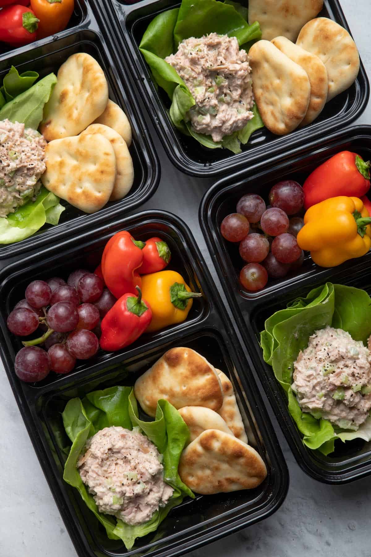 Tuna salad meal prep containers with vegetables and fruit