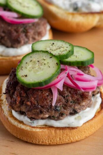 Opened lamb burgers on cutting board