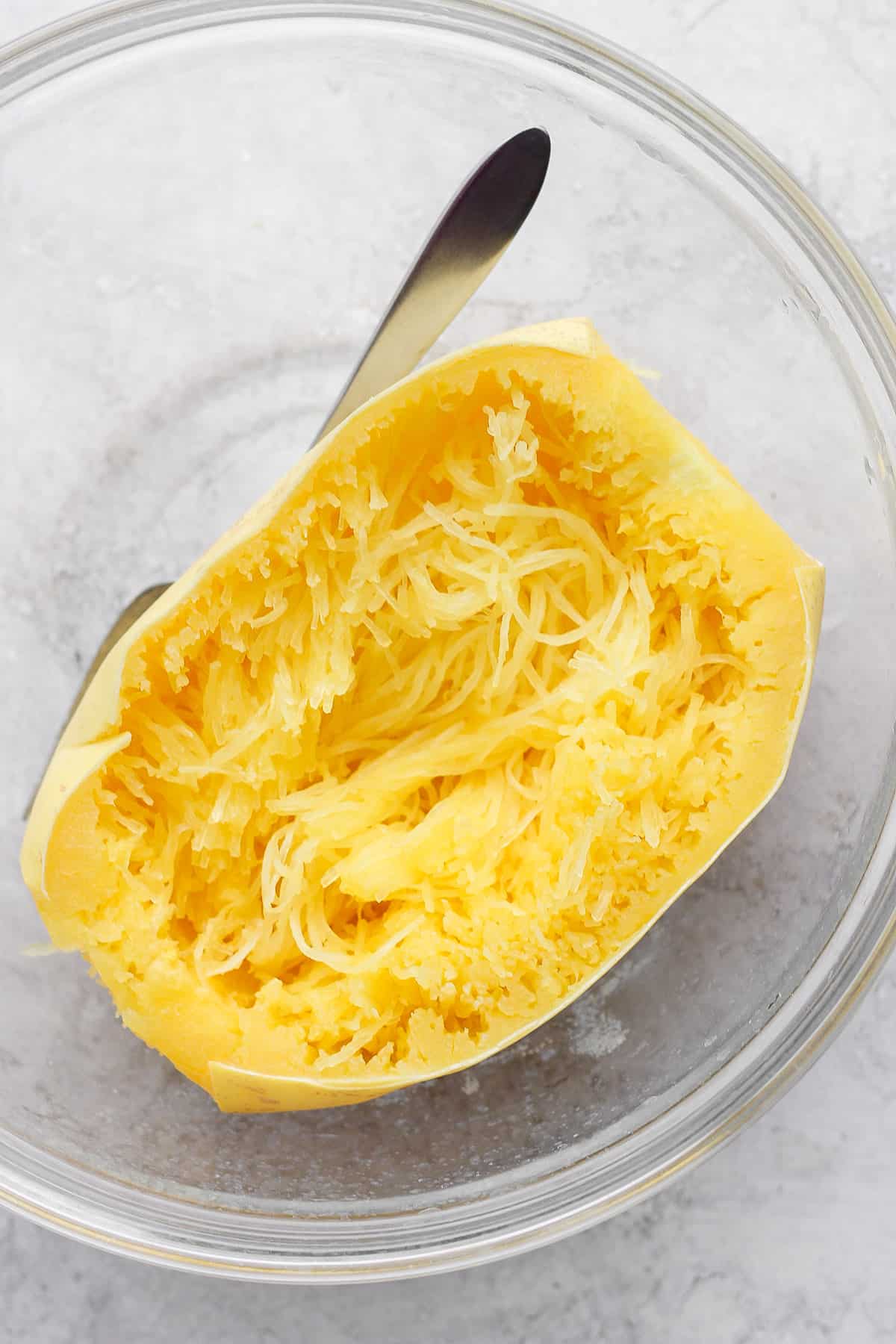 Large bowl with spaghetti squash and fork for pulling strands