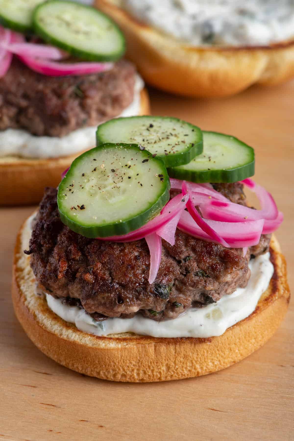 Opened lamb burgers on cutting board