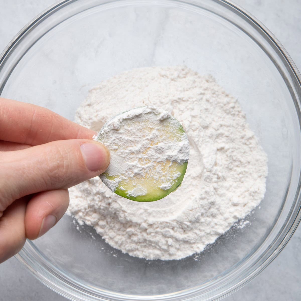 Dip zucchini in flour.