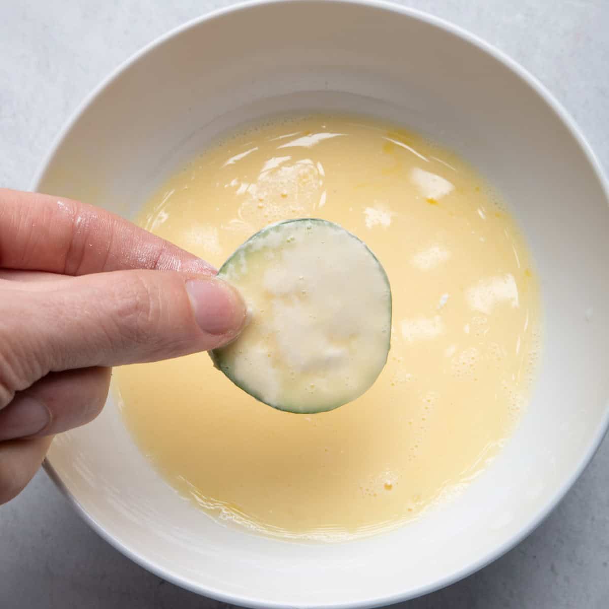 Dip zucchini in egg mixture.