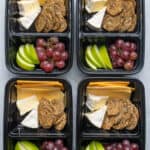 Meal prep containers with cheese, fruit and crackers