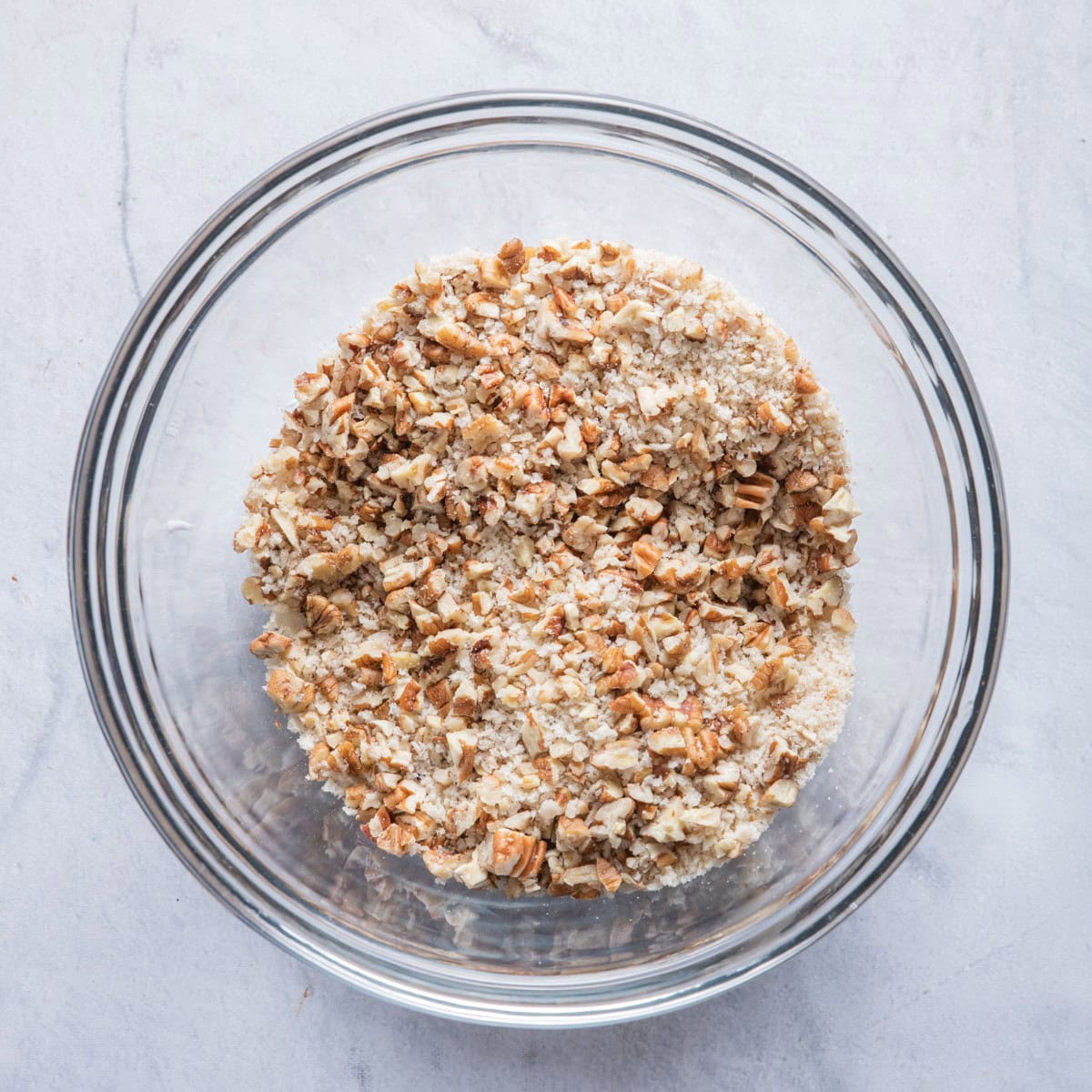 Another shallow bowl with pecans and breadcrumbs mixture.