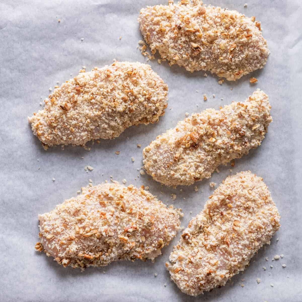 Chicken on baking sheet before going in oven.