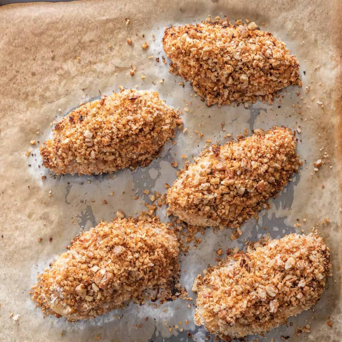 Chicken on baking sheet after going in oven.