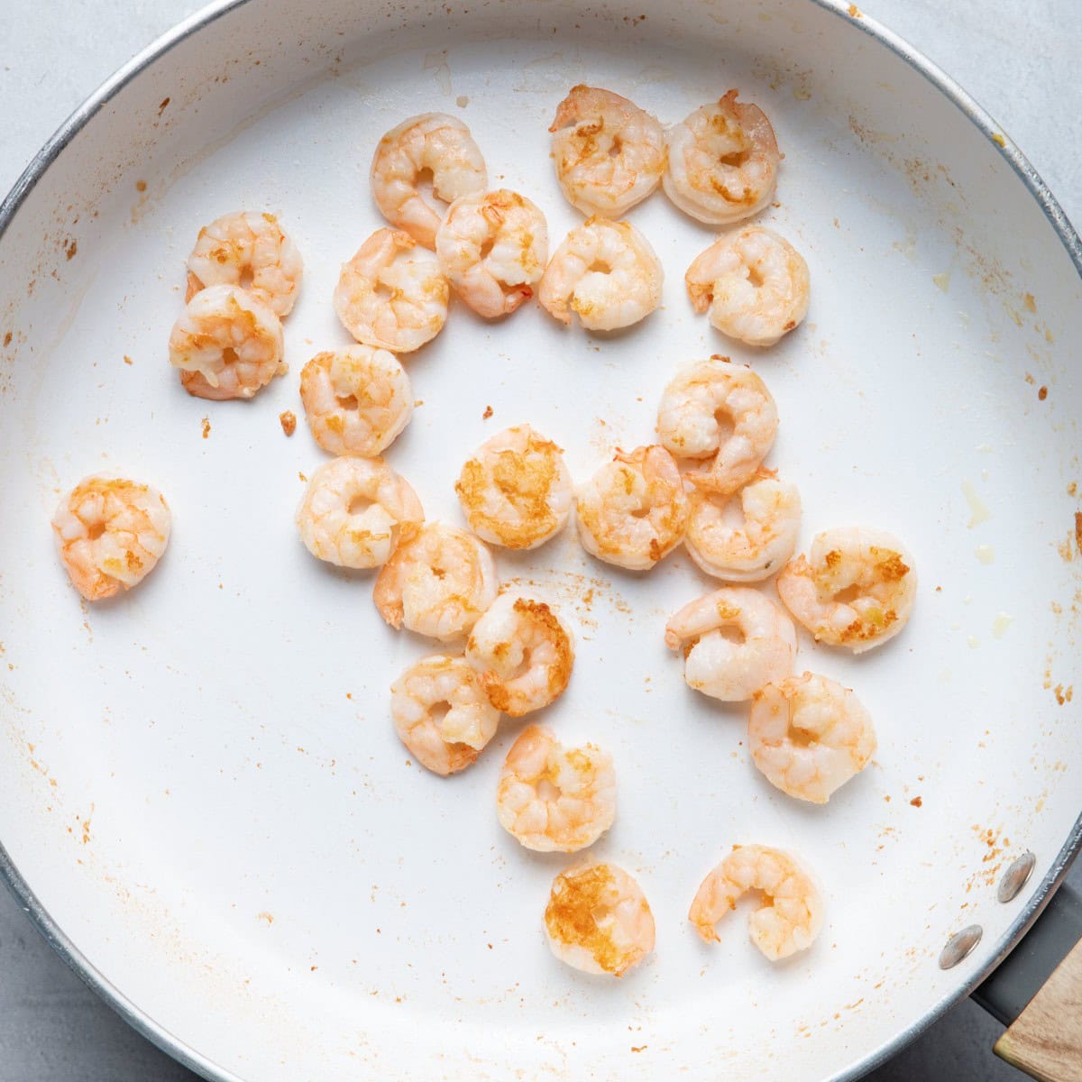 Cooked shrimp in large sauté pan.