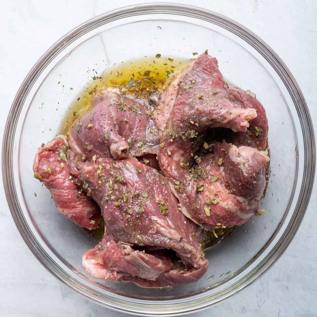 Marinated steak in bowl.