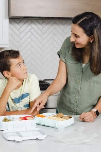 Yumna with son (Adam) pointing at lunchboxes