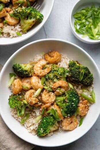 Shrimp and broccoli stir fry in bowls over brown rice