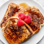Plate of french toast served with berries and maple syrup