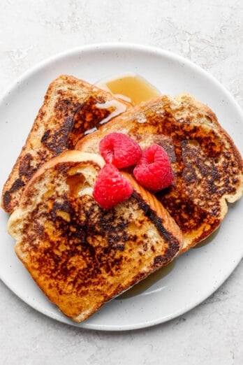 Plate of french toast served with berries and maple syrup
